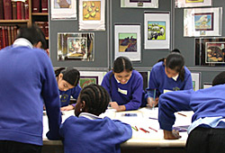 Photograph of pupils working on their Young Cutural Creators stamp designs at The Royal Mail Archive